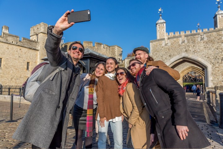 a group of people taking a selfie in front of a building