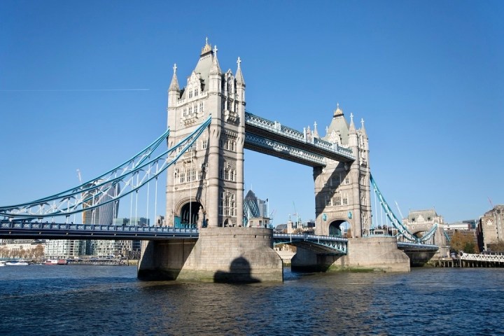 a large ship in the water near a bridge