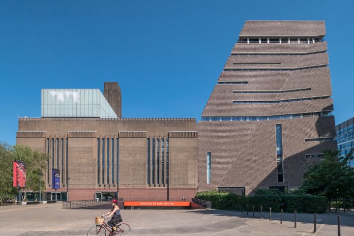 a person riding a horse in front of a building